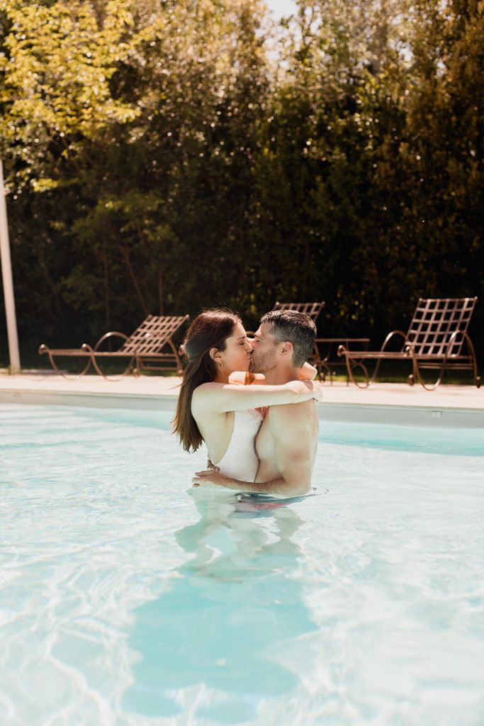 Romantic pool wedding moment Château Grand Boise Provence Bride and groom kissing in pool at Château Grand Boise Provence wedding venue during golden hour by Maxime Bernadin