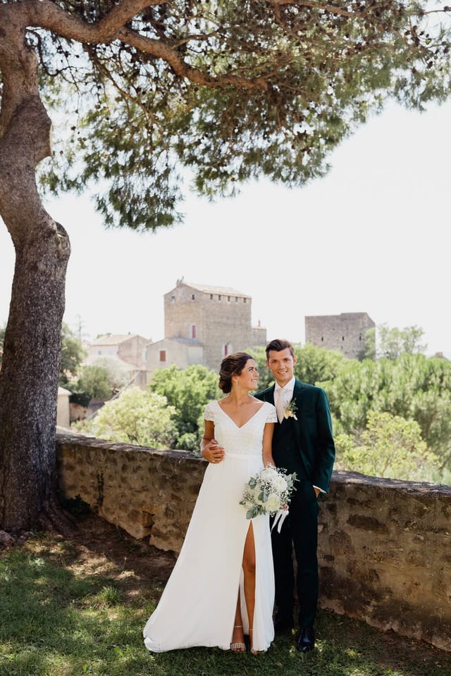Timeless portrait beneath plane trees – Domaine des Barrenques. Bride and groom pose under century‑old plane trees at Domaine des Barrenques in Provence, photographed by Maxime Bernadin.